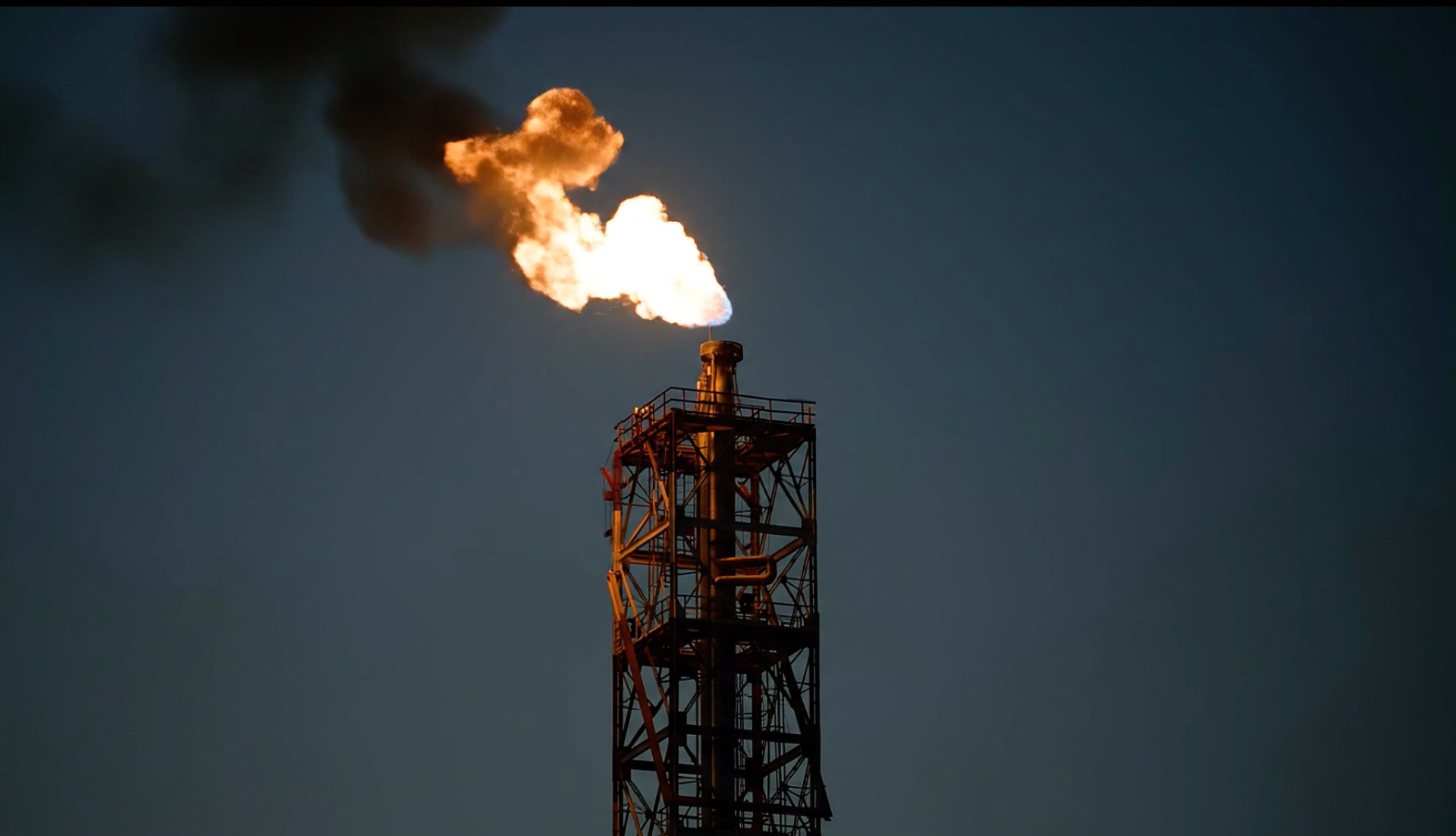 Flare stack burning over an offshore platform